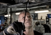 a man working on a car in a garage