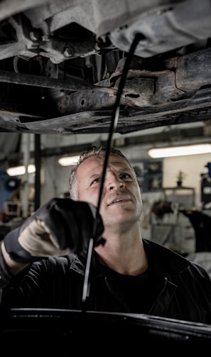 a man working on a car in a garage