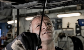 a man working on a car in a garage