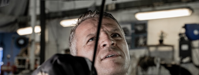 a man working on a car in a garage