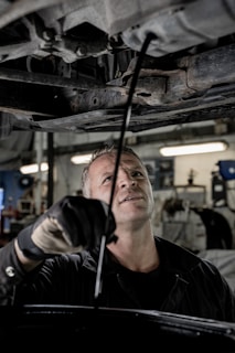 a man working on a car in a garage