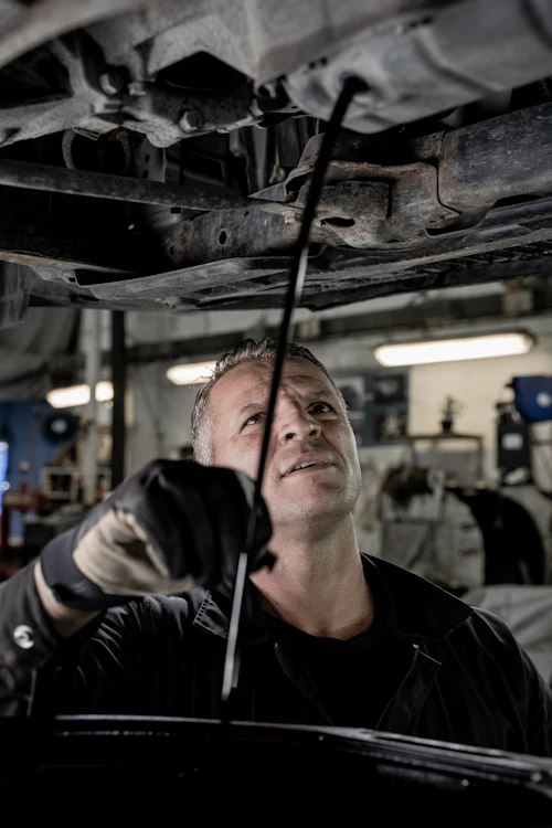 Technician working on a vehicle in a workshop
