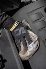 a glove that is sitting on the hood of a car