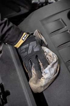 a glove that is sitting on the hood of a car