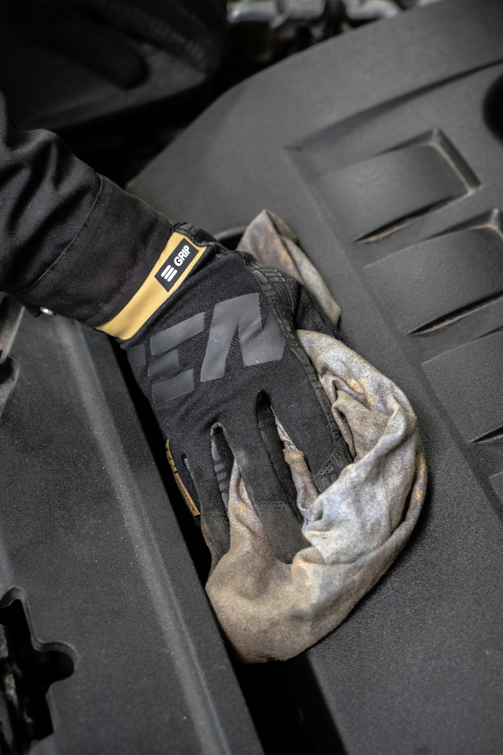 a glove that is sitting on the hood of a car