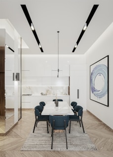a dining room with a large white table surrounded by blue chairs