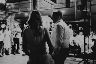 a black and white photo of a couple dancing