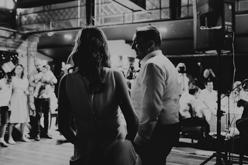 a black and white photo of a couple dancing