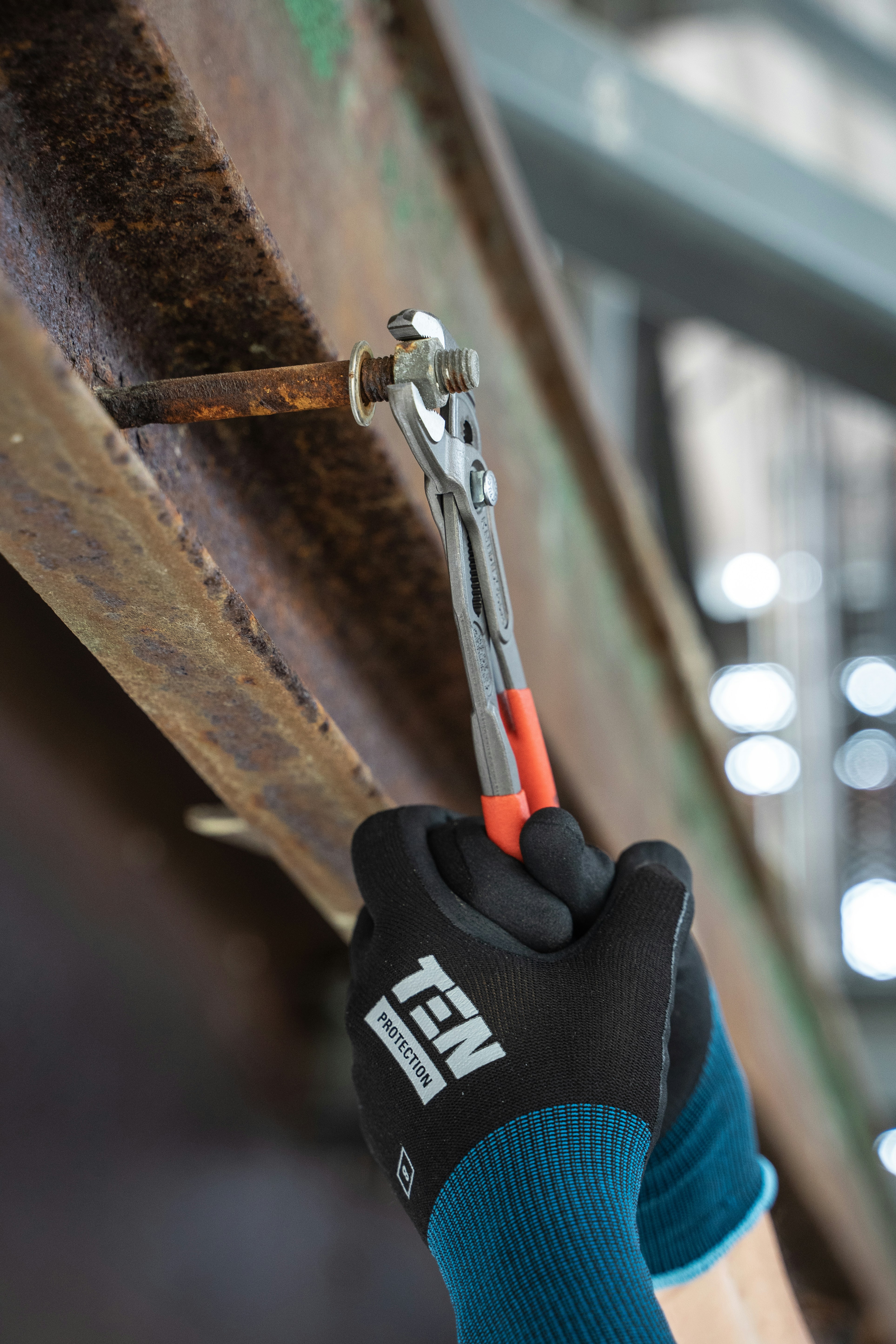 a person holding a wrench in their right hand