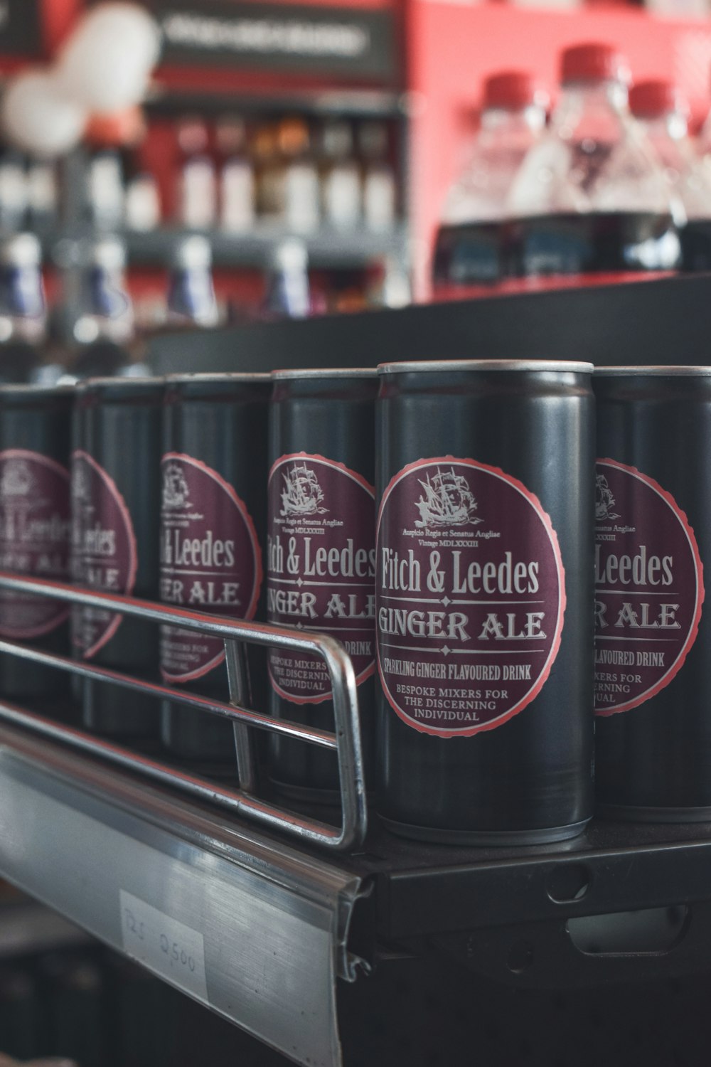 a row of beer cans sitting on top of a conveyor belt