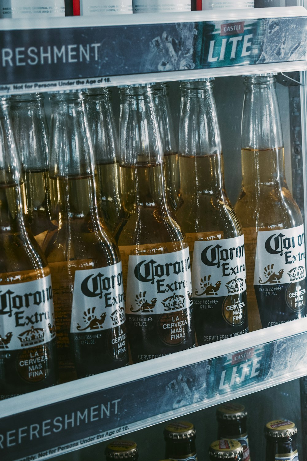 a refrigerator filled with lots of bottles of beer