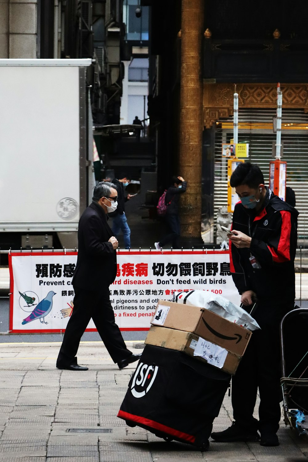 a man in a face mask walking down a street