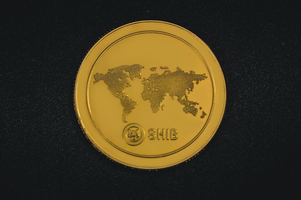 a gold coin with a world map on it