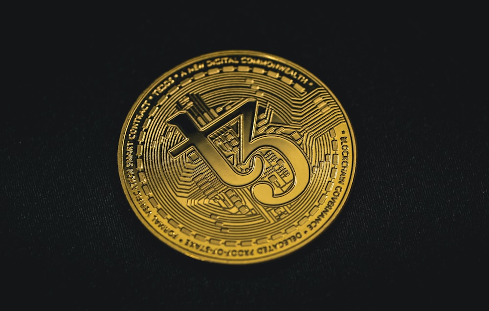 a gold coin with the letter s on it