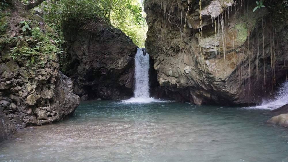 a small waterfall in the middle of a canyon