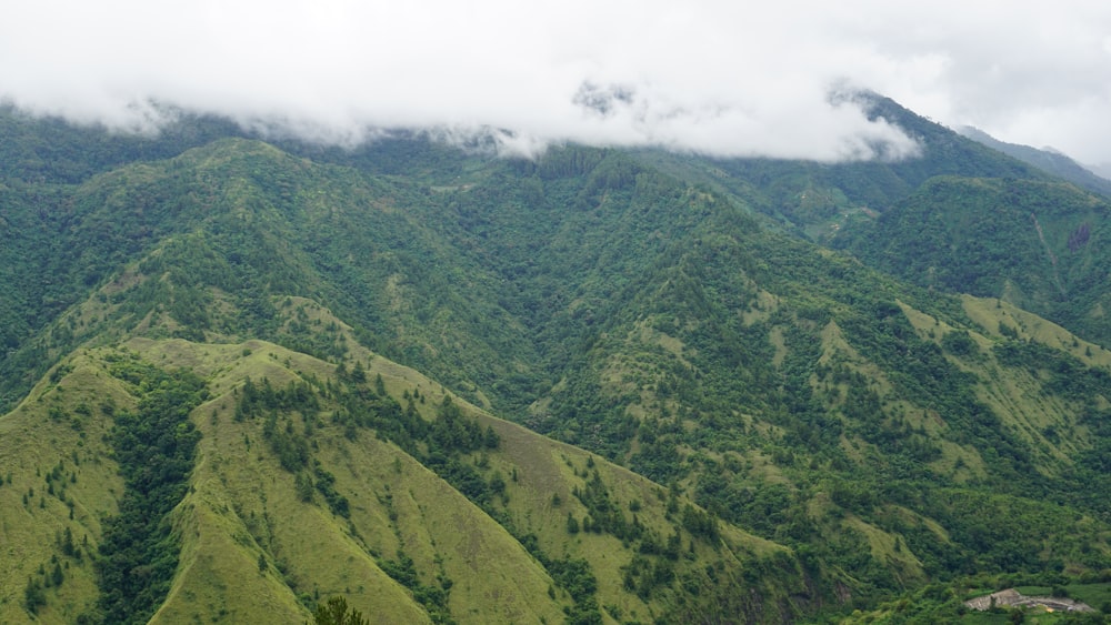 a view of a mountain range covered in clouds