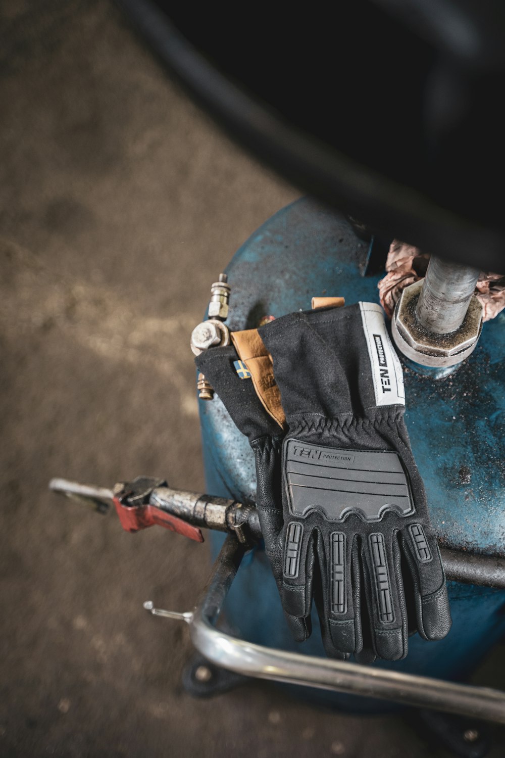 a pair of gloves sitting on top of a blue object