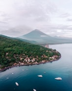 a group of boats floating on top of a body of water