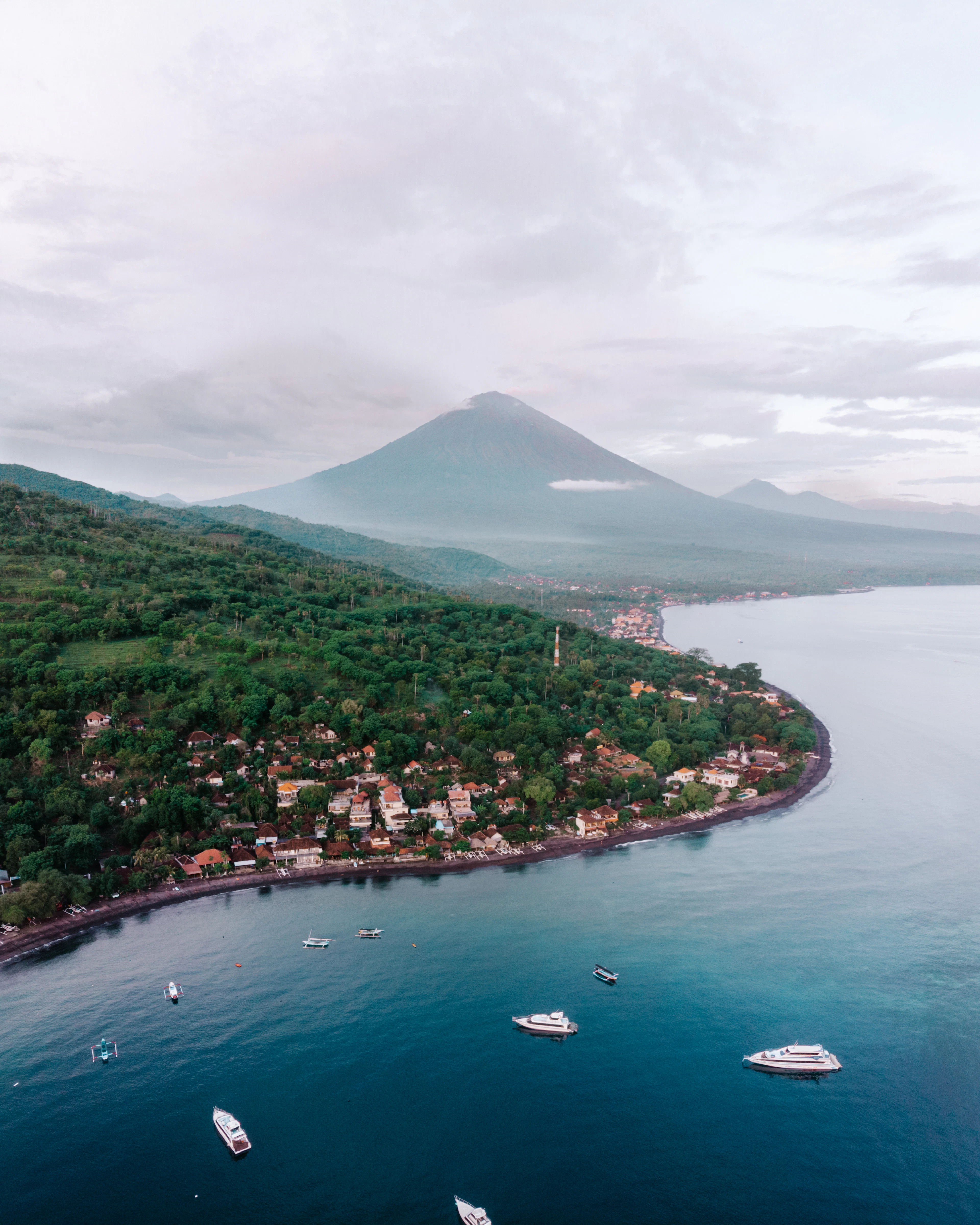 The coastal village of Amed and boats in the bay beneath Mount Agung, east Bali