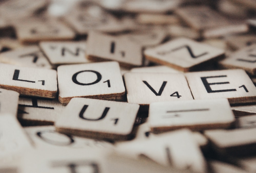 a close up of scrabble letters spelling love