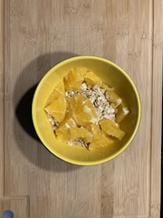 Bowls with natural ingredients like honey, avocado, and oats arranged on a wooden table
