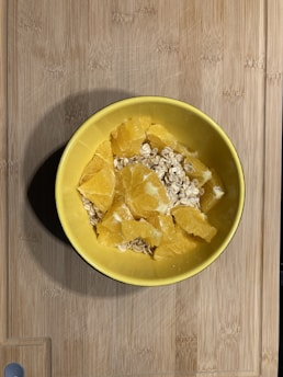Bowls with natural ingredients like honey, avocado, and oats arranged on a wooden table