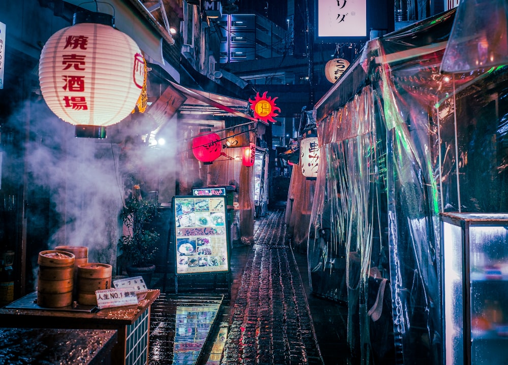 a narrow alley with a lot of lanterns hanging from the ceiling