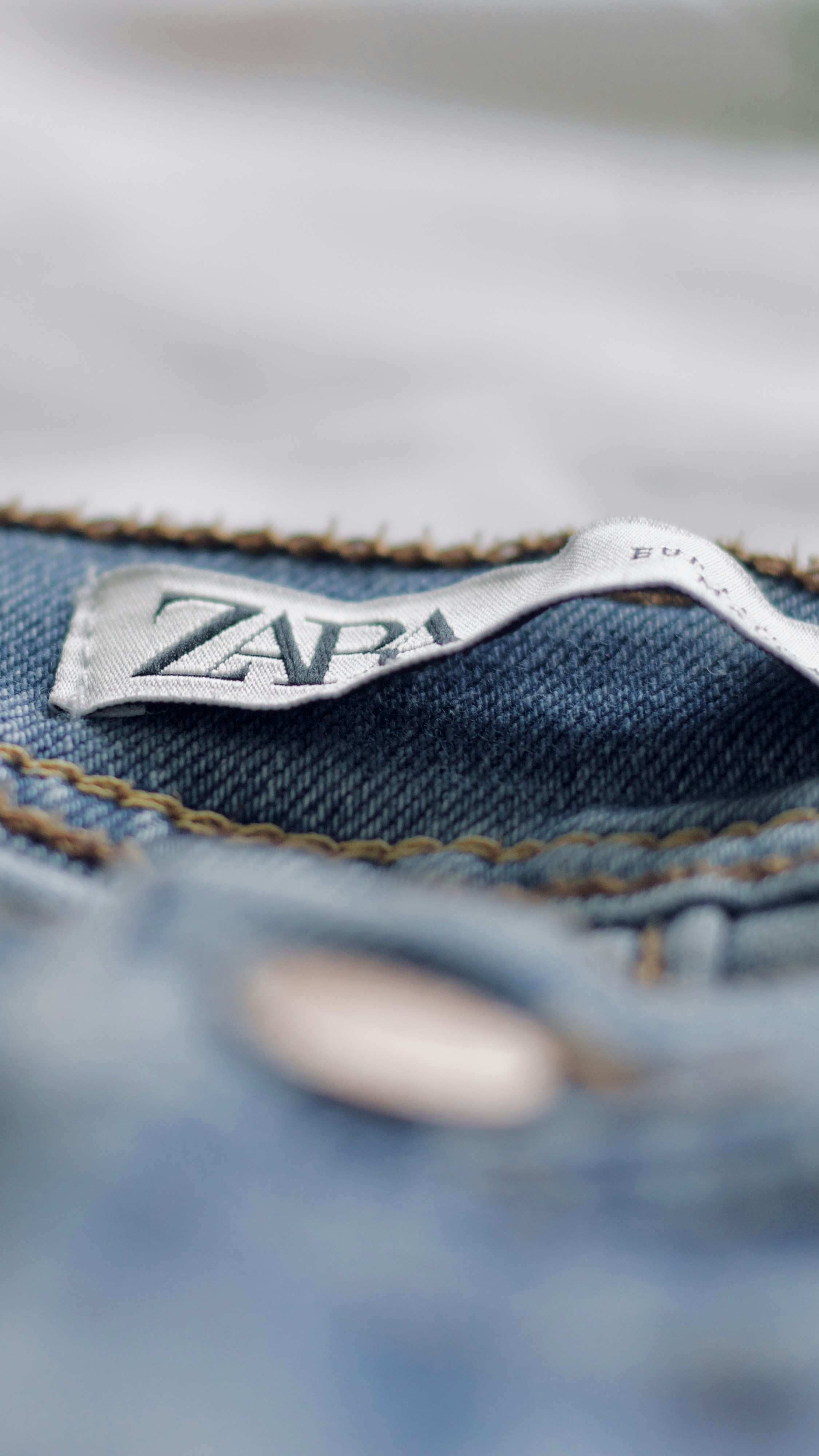 a close up of a pair of jeans with a logo on it