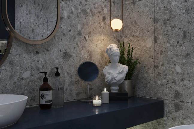 Sleek modern bathroom with marble countertops and gold fixtures glowing under soft lighting.