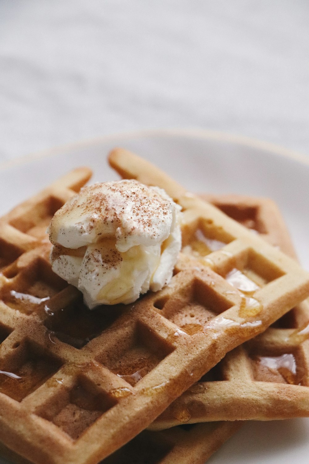 a waffle with a scoop of ice cream on top of it