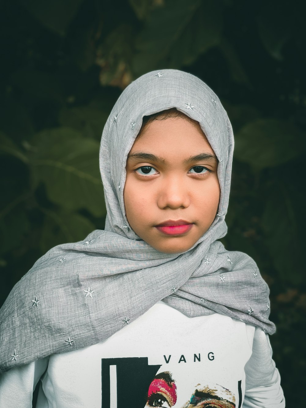 a young girl with a scarf around her head