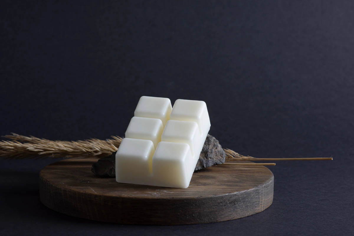 Hand-poured wax melts in pastel colours arranged on a clean surface