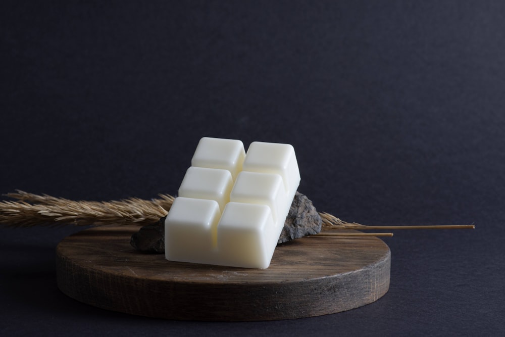 a block of wax sitting on top of a wooden board