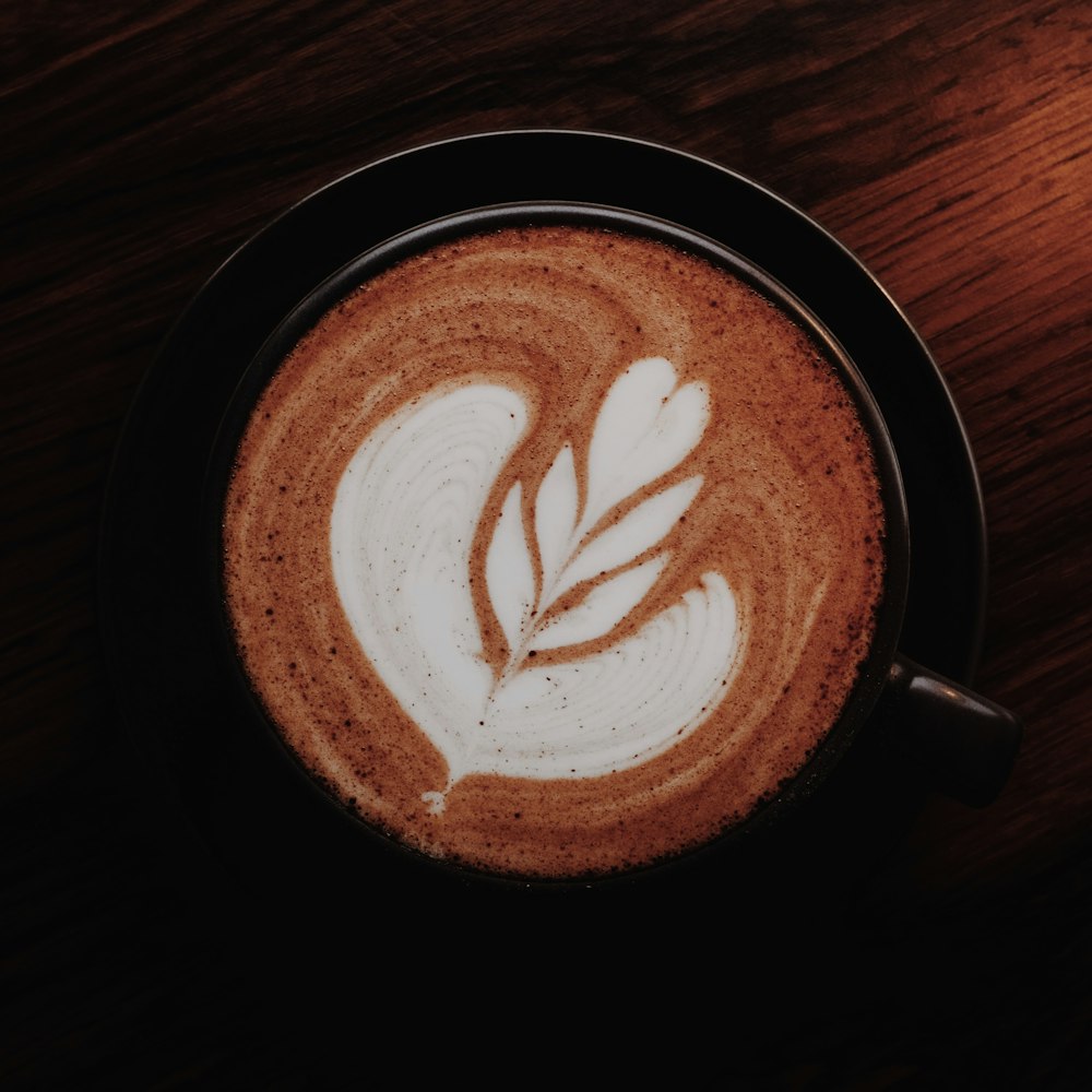 a cappuccino with a leaf drawn on it