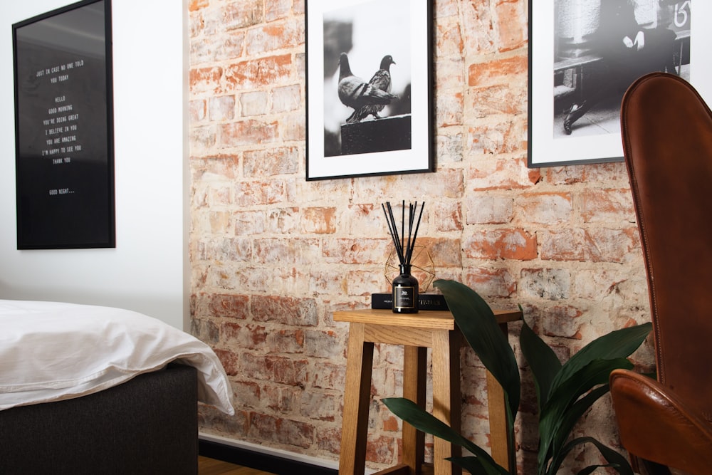 a bedroom with a brick wall and a bed