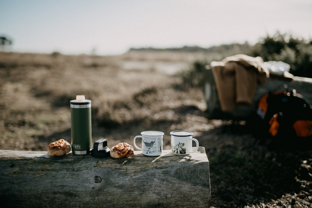 a couple of cups sitting on top of a wooden table