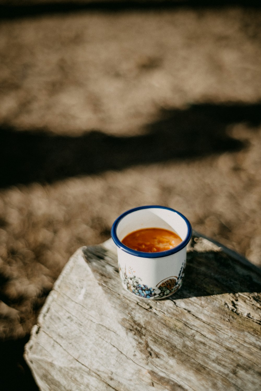 a cup of coffee sitting on top of a wooden table