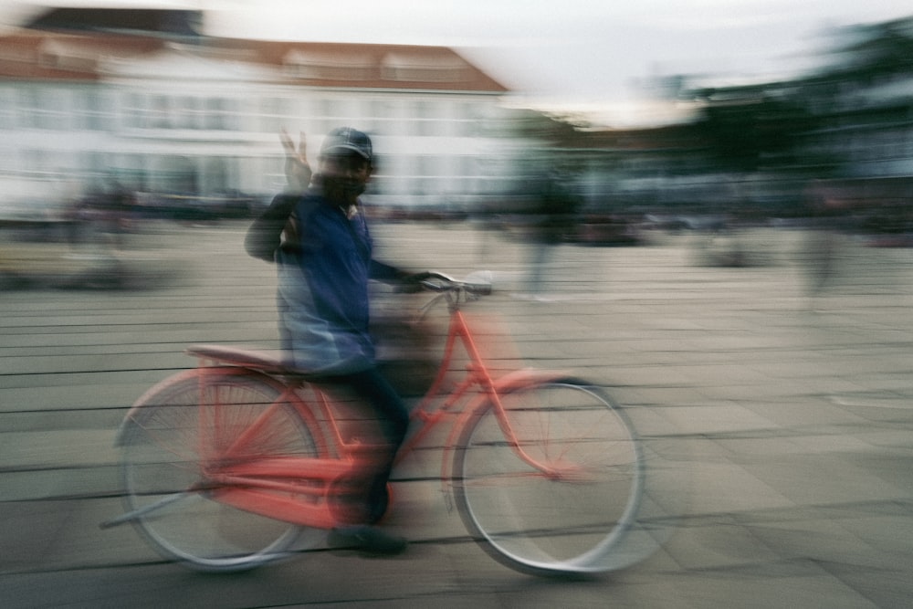 a blurry photo of a person riding a bike