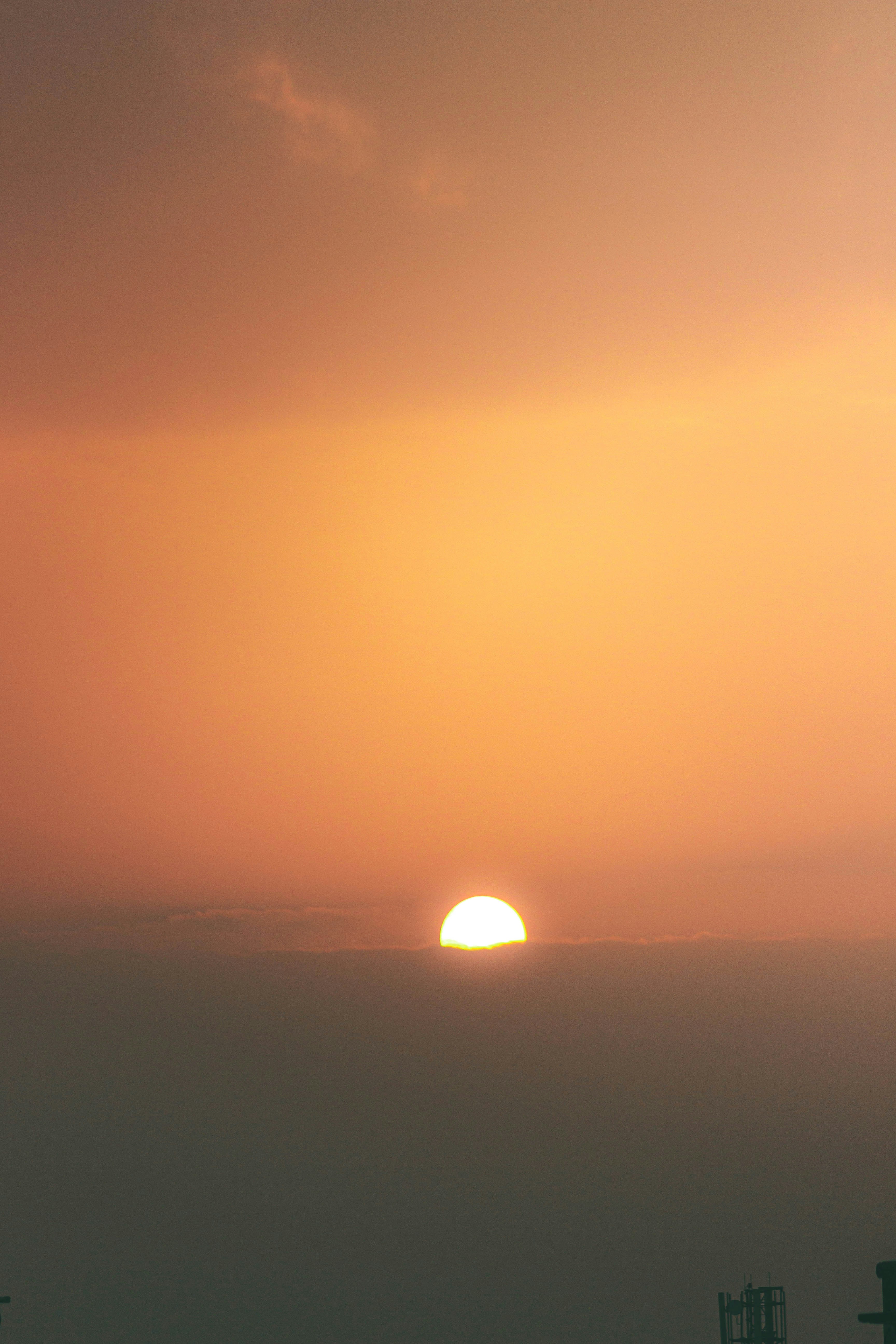 the sun is setting over the horizon of a city