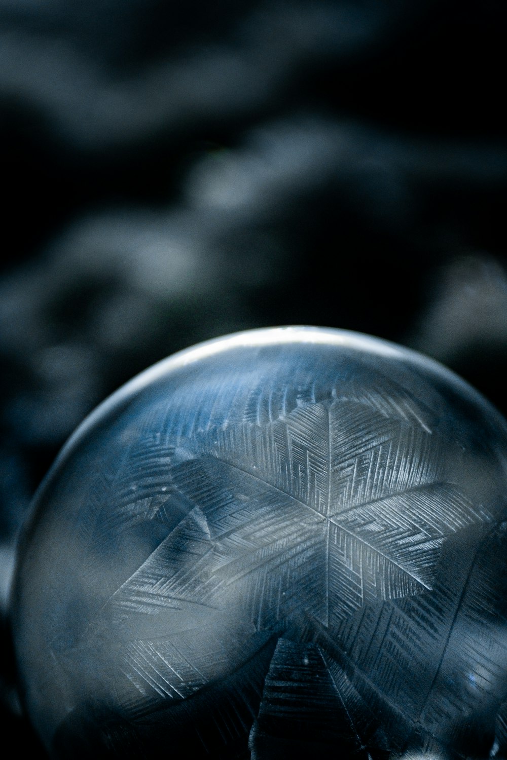 a glass ball with a snowflake design on it
