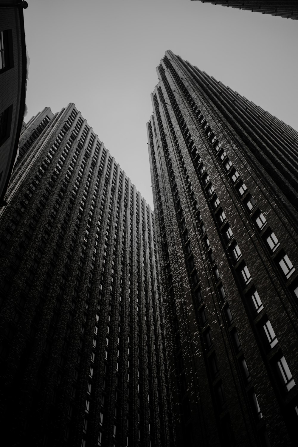 a black and white photo of two tall buildings