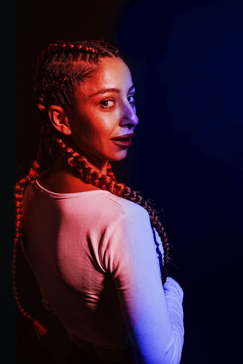 a woman with braids standing in the dark