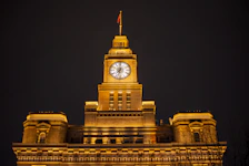 Fairmont Clock Tower hotel exterior illuminated at night with the holy city backdrop.