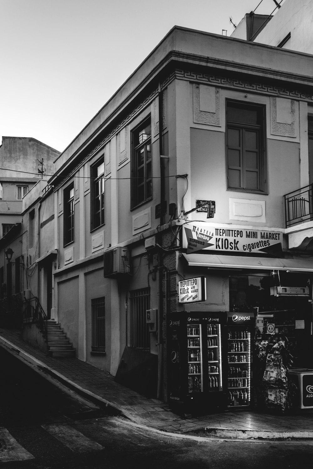 a black and white photo of a street corner