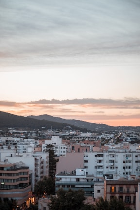 A panoramic view of Prishtina's skyline at sunset.
