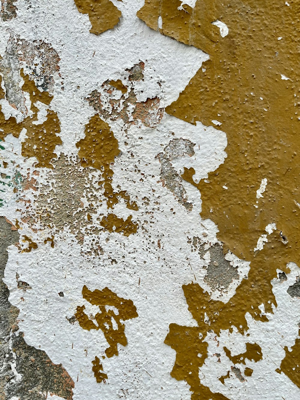 a close up of a peeling paint on a wall