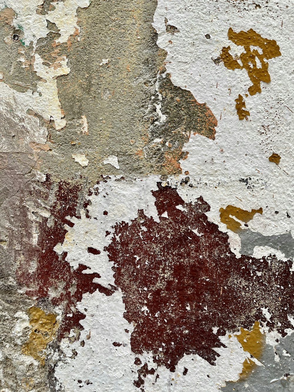 a close up of a wall with peeling paint