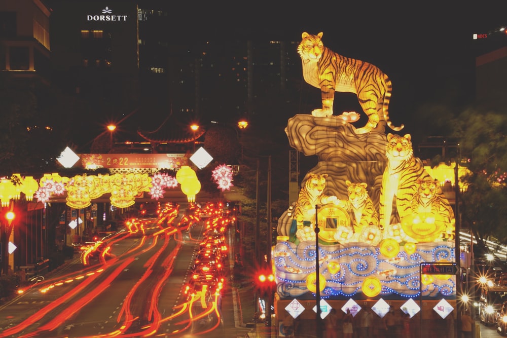 a night scene of a street decorated with lights and decorations