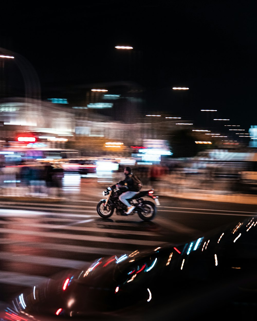 a person riding a motorcycle on a city street