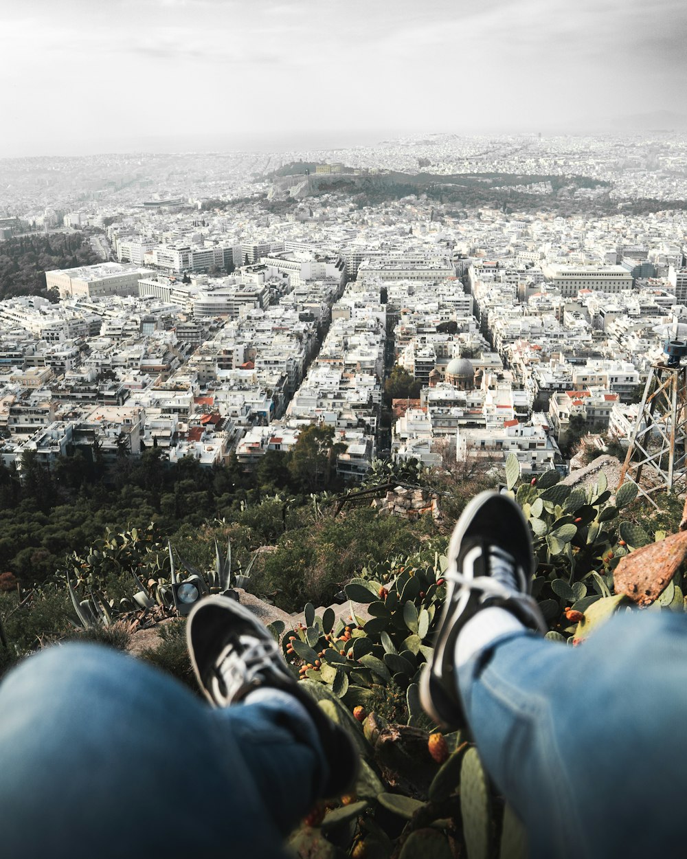 a person with their feet up in the air above a city